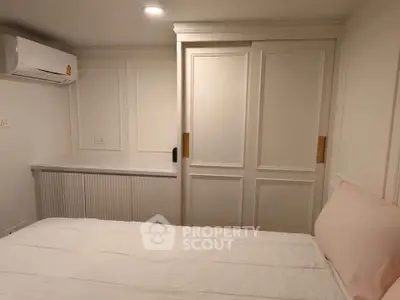 Cozy bedroom with built-in wardrobe and air conditioning unit