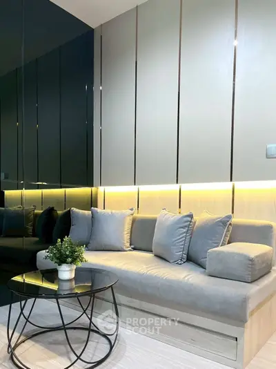 Modern living room with sleek sofa, stylish coffee table, and ambient lighting