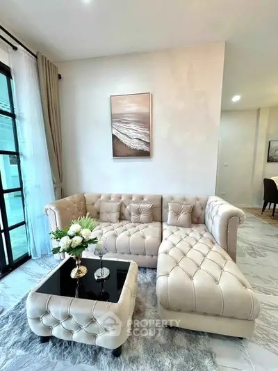 Elegant living room with plush beige sofa and chic decor