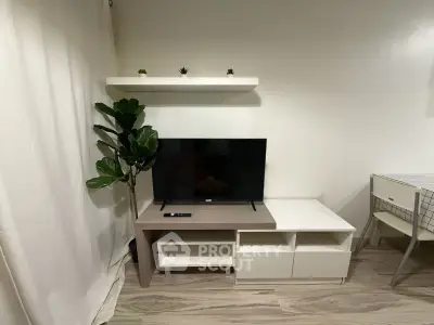 Modern living room with sleek TV stand, minimalist decor, and stylish flooring.