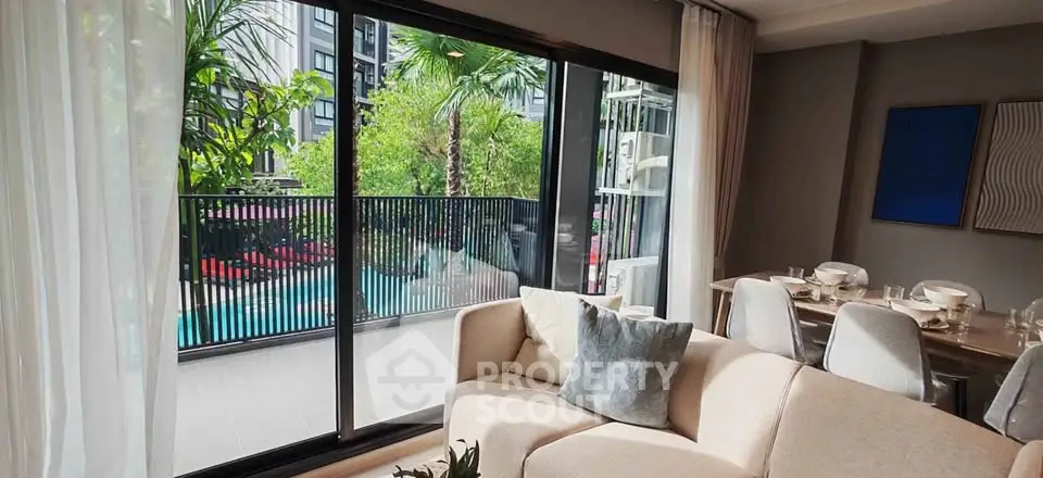 Modern living room with pool view and elegant dining area, perfect for luxury urban living.