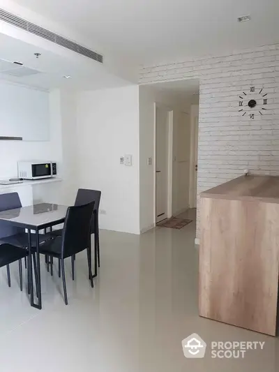 Modern dining area with sleek furniture and minimalist decor in a stylish apartment