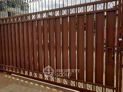 Sturdy metal gate providing secure entrance to residential property.