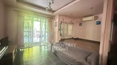 Spacious living room with modern decor and large windows for natural light