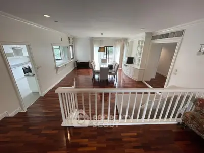 Spacious living room with elegant wooden flooring and modern dining area, perfect for family gatherings.