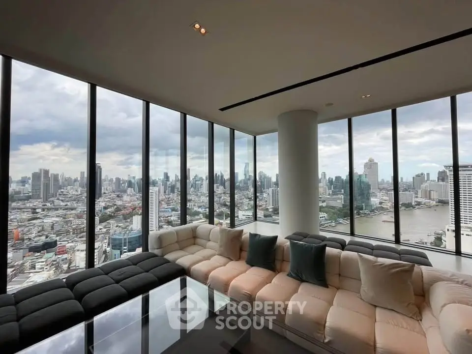 Luxurious corner unit living room with panoramic city skyline views and modern furnishings.