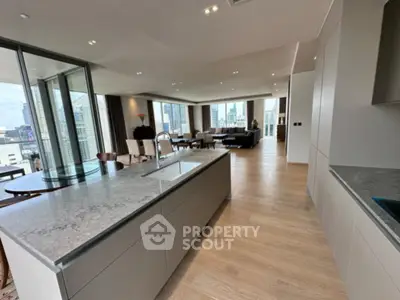 Luxurious open-plan kitchen and living room with city skyline views