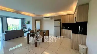 Spacious open-plan living and dining area with modern kitchen and large windows.