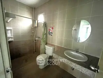 Spacious bathroom with modern fixtures and tiled walls in a contemporary home.