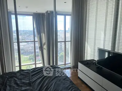 Modern bedroom with city view and sleek furnishings in high-rise apartment