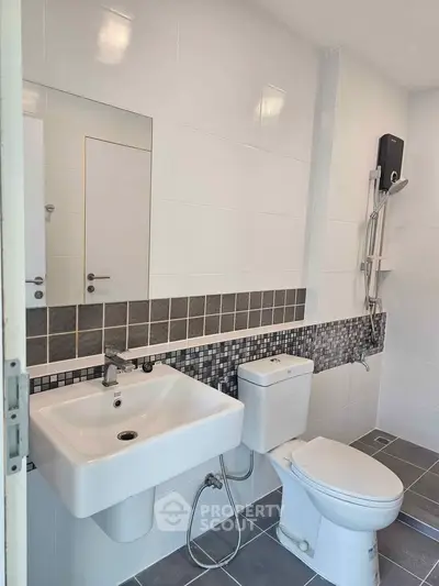 Modern bathroom with sleek fixtures and stylish tile accents.