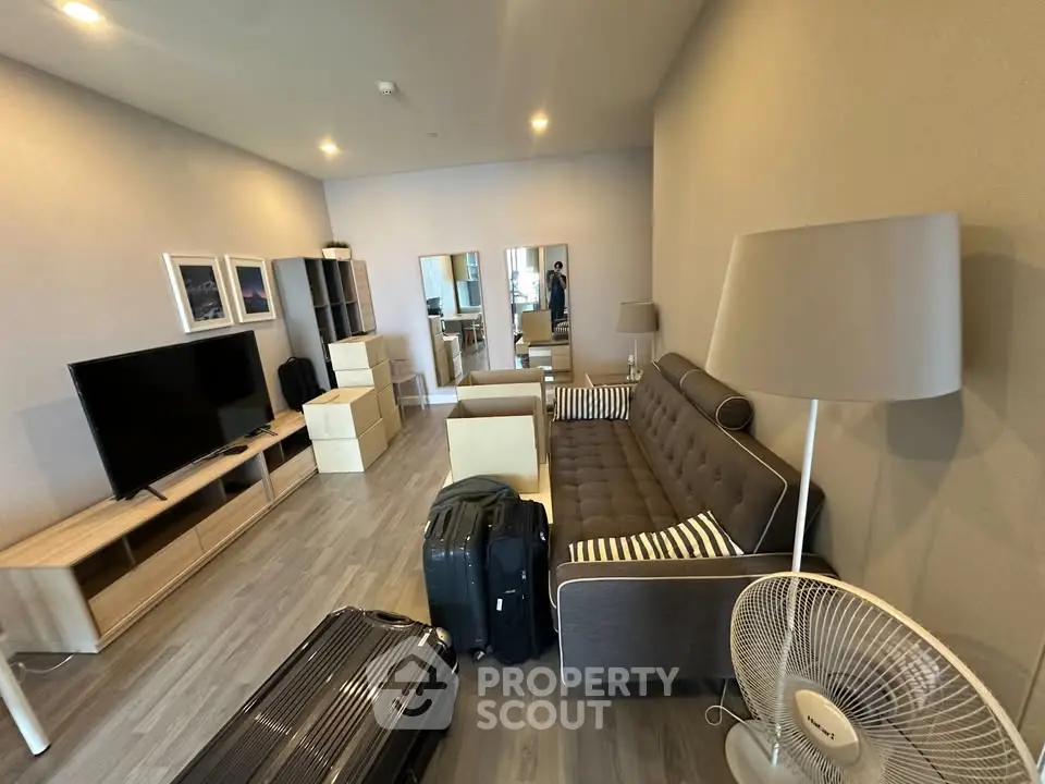 Spacious modern living room with stylish furniture and entertainment setup.