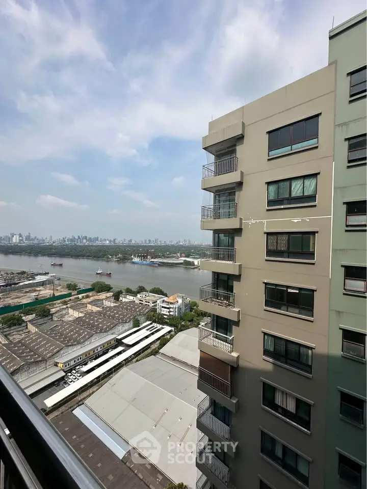 Stunning high-rise building with river view and city skyline in the background.