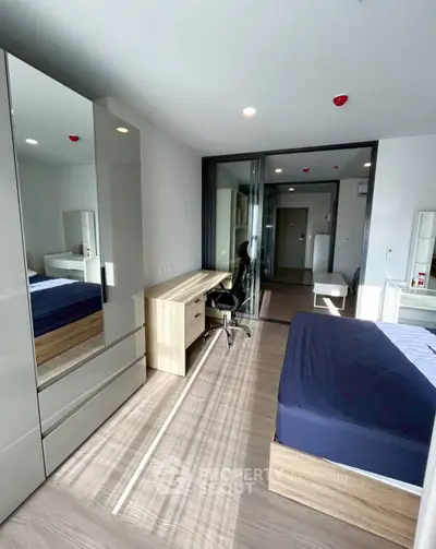 Modern bedroom with sleek furniture and ample natural light