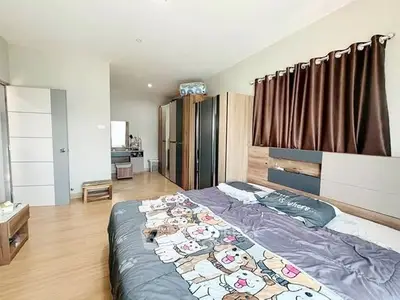 Spacious bedroom with modern decor and ample natural light