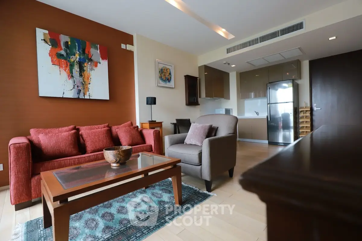 Modern living room with stylish furniture and open kitchen layout in a contemporary apartment.
