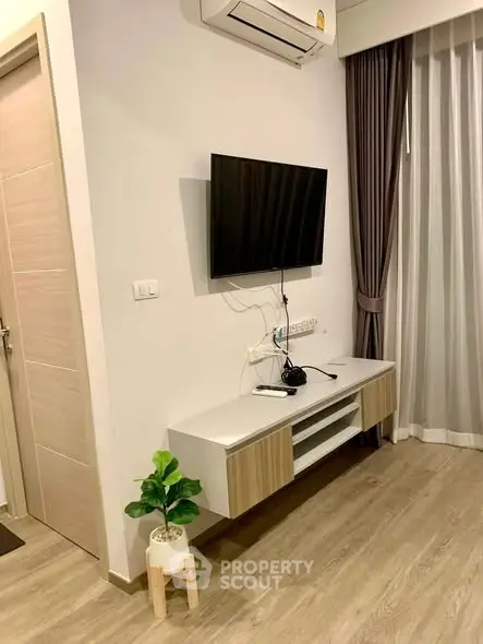 Modern living room with wall-mounted TV and stylish decor