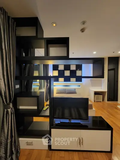 Modern living room with stylish black shelving and cozy ambiance