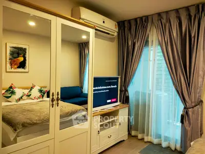 Cozy bedroom with mirrored wardrobe and elegant curtains in modern apartment