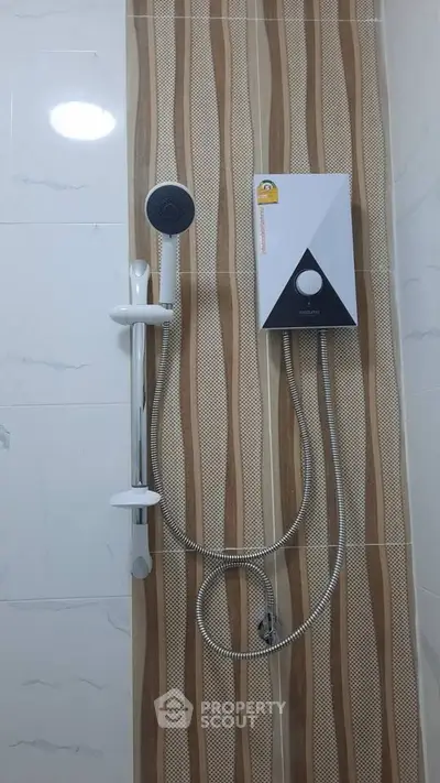 Modern bathroom with sleek shower panel and stylish tile design