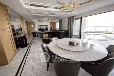 Luxurious living room with marble dining table and large balcony view.