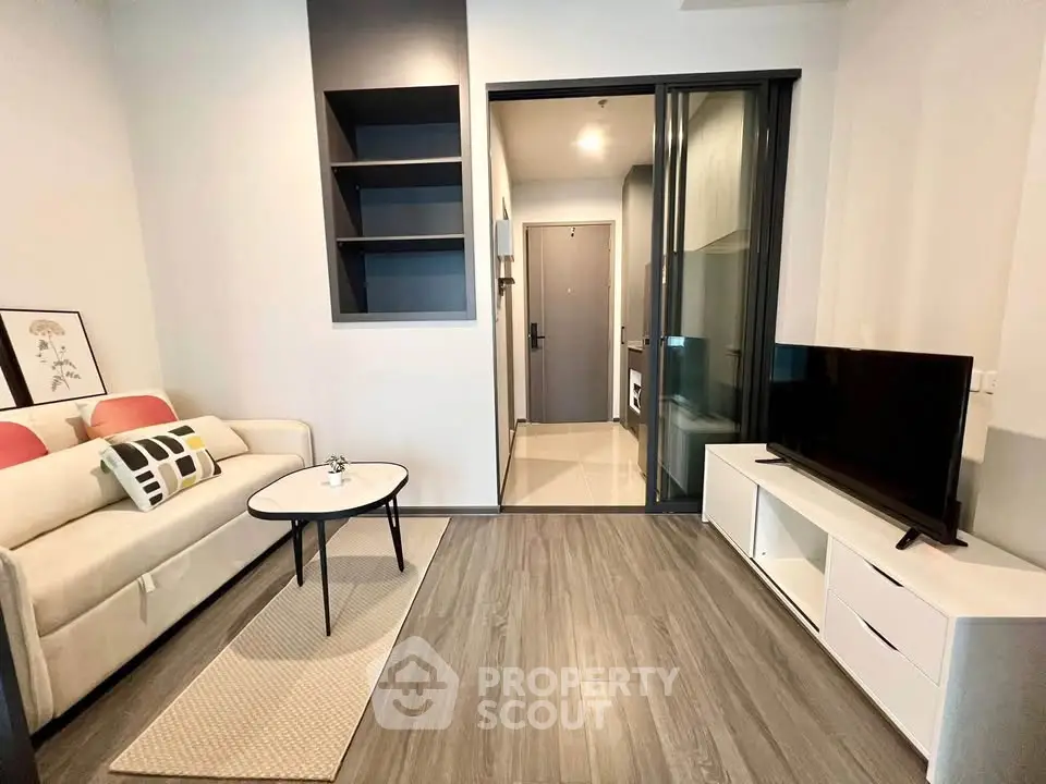 Modern living room with sleek design, featuring a cozy sofa, stylish coffee table, and a flat-screen TV.