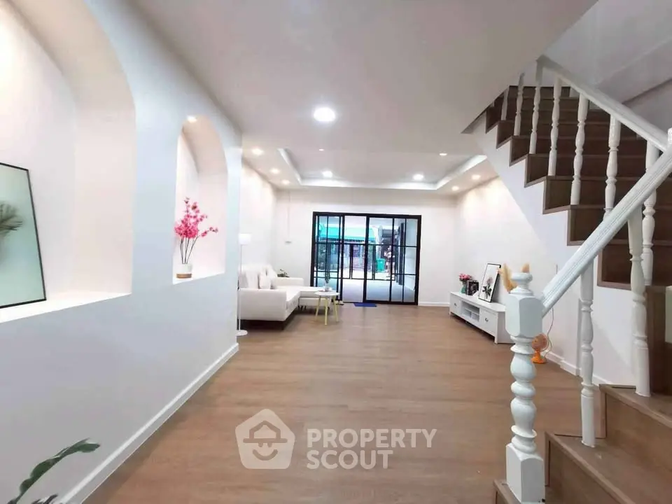 Spacious modern living room with elegant staircase and stylish decor