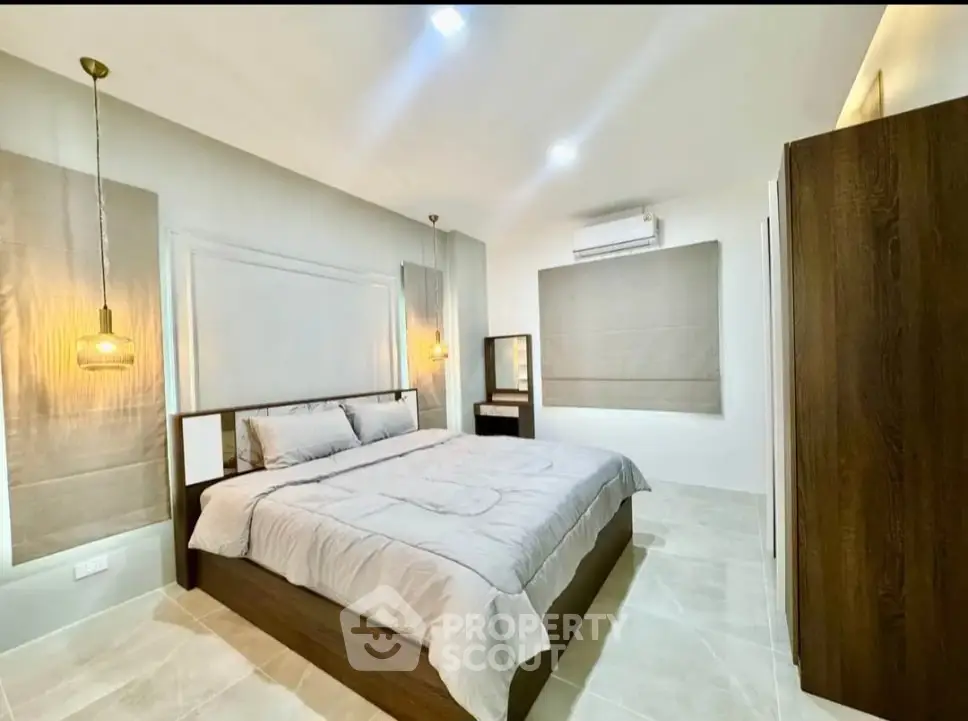 Spacious modern bedroom with elegant lighting and stylish decor