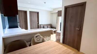 Modern open-plan living area with sleek kitchen and cozy seating, perfect for urban living.