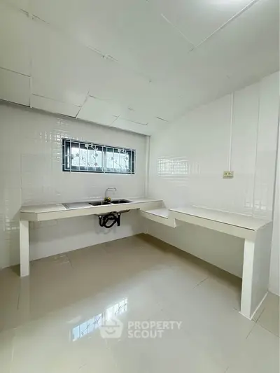 Spacious kitchen with sleek countertops and modern design