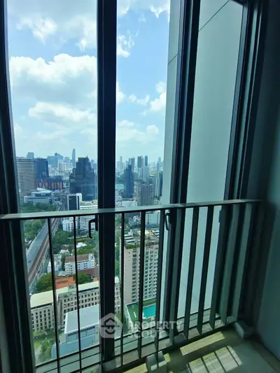 Stunning cityscape view from a high-rise balcony with modern railing.