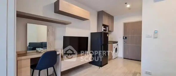Modern studio apartment with sleek furniture and appliances, ideal for urban living.