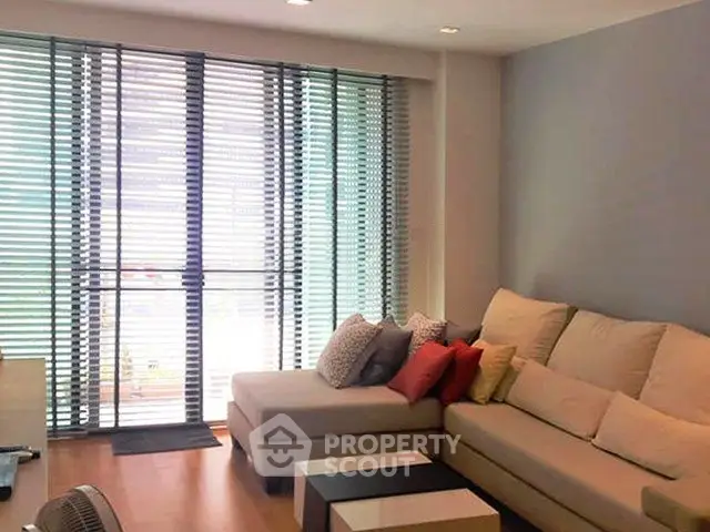 Modern living room with large windows and stylish sectional sofa