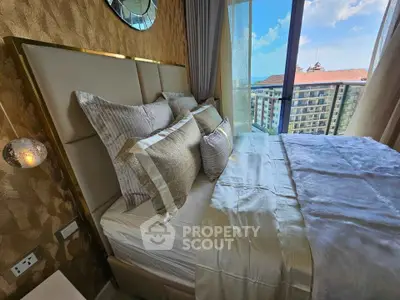 Luxurious bedroom with elegant decor and stunning balcony view in high-rise apartment.