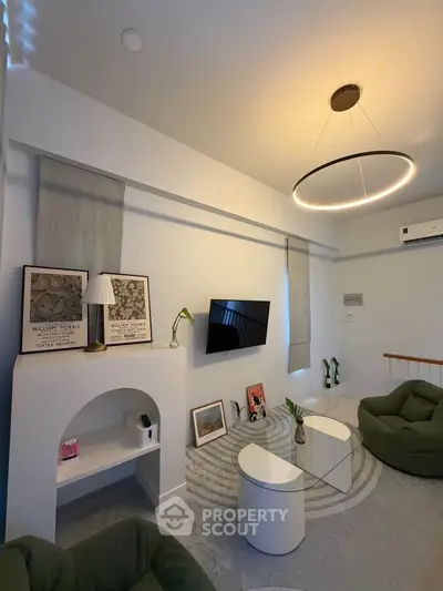 Modern living room with stylish furniture and unique lighting, perfect for cozy gatherings.