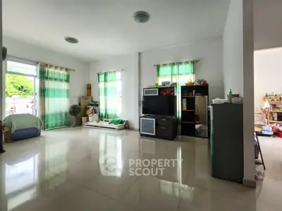 Spacious living room with natural light and modern decor in a cozy home.