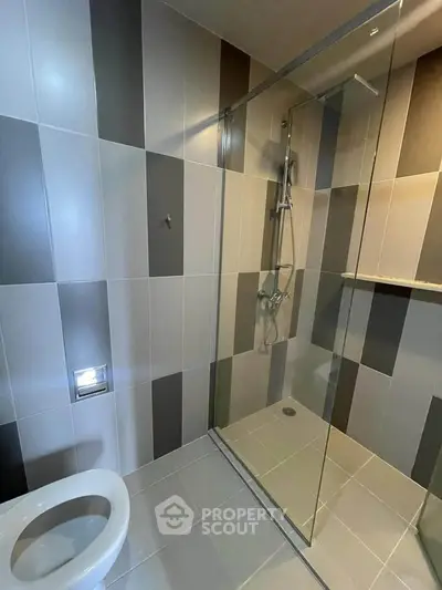 Modern bathroom with sleek glass shower and stylish tile design