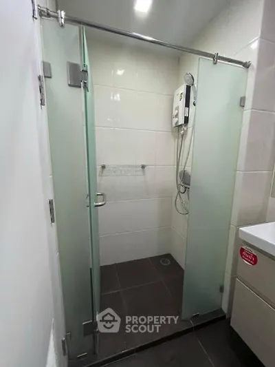 Modern bathroom with glass shower doors and sleek fixtures