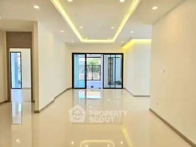 Spacious modern living room with glossy floors and large windows.