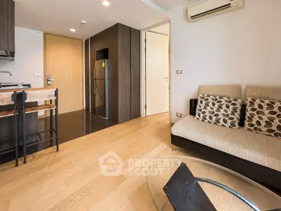 Modern living room with open kitchen and stylish decor in a cozy apartment.