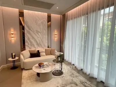 Luxurious living room with elegant decor and large windows for natural light.