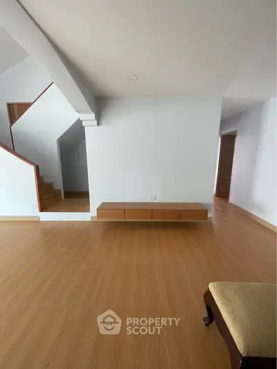 Spacious modern living room with wooden flooring and minimalist design