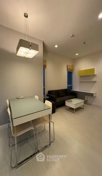 Modern living room with sleek furniture and stylish lighting in a cozy apartment setting.