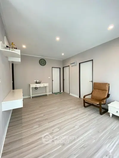 Spacious minimalist living room with modern decor and elegant flooring