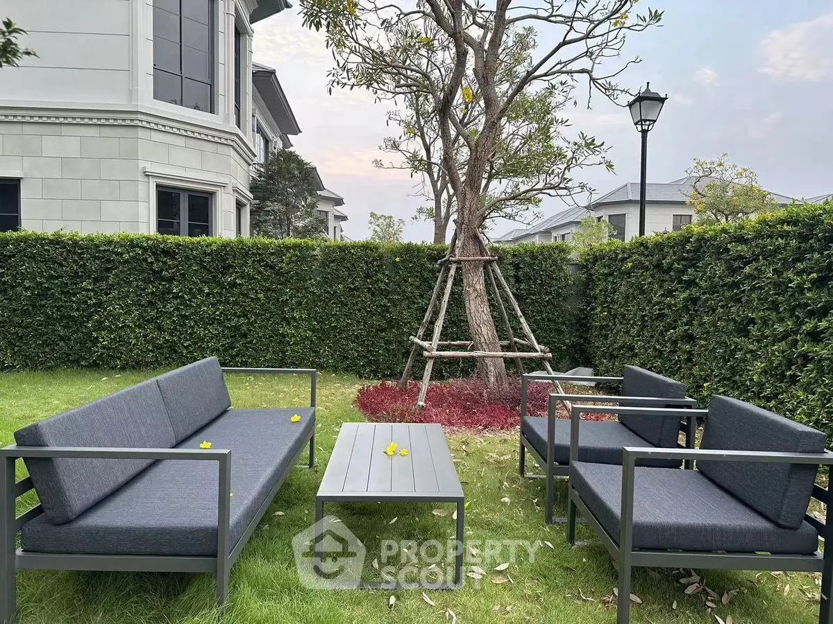 Charming garden seating area with modern outdoor furniture and lush greenery.