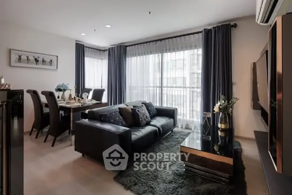 Modern living room with elegant dining area and large windows in luxury apartment.