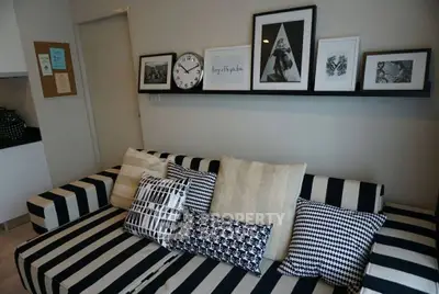 Stylish living room with striped sofa and modern wall art