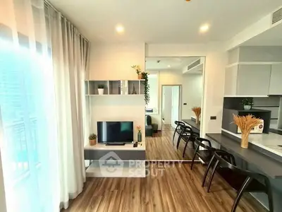 Modern open-layout living room with stylish decor and natural light