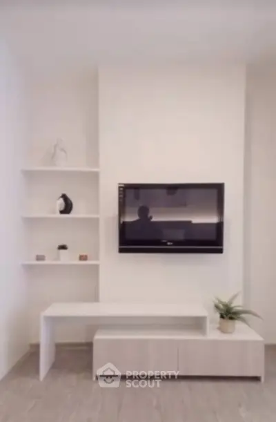 Modern living room with wall-mounted TV and minimalist decor