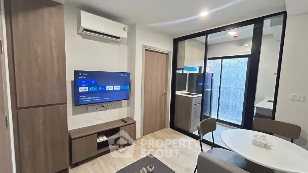 Modern living room with smart TV and balcony access in stylish apartment